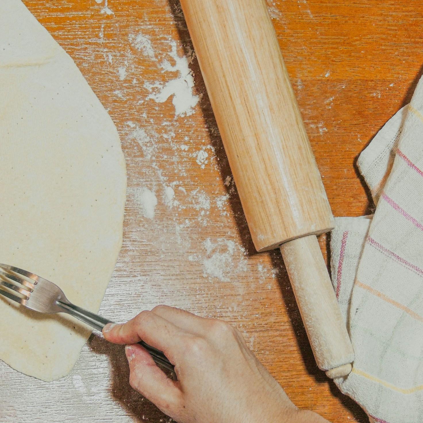 Diverse group of community members sharing a meal together, showcasing the social bonds formed through collaborative cooking